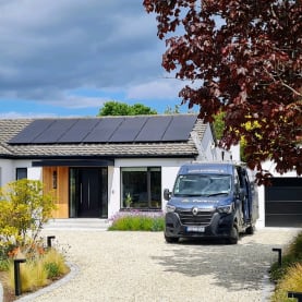 Solar panels on roof, with Purevolt EV parked in the driveway
