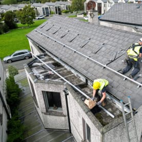Solar panel installation team on a rooftop in Ireland